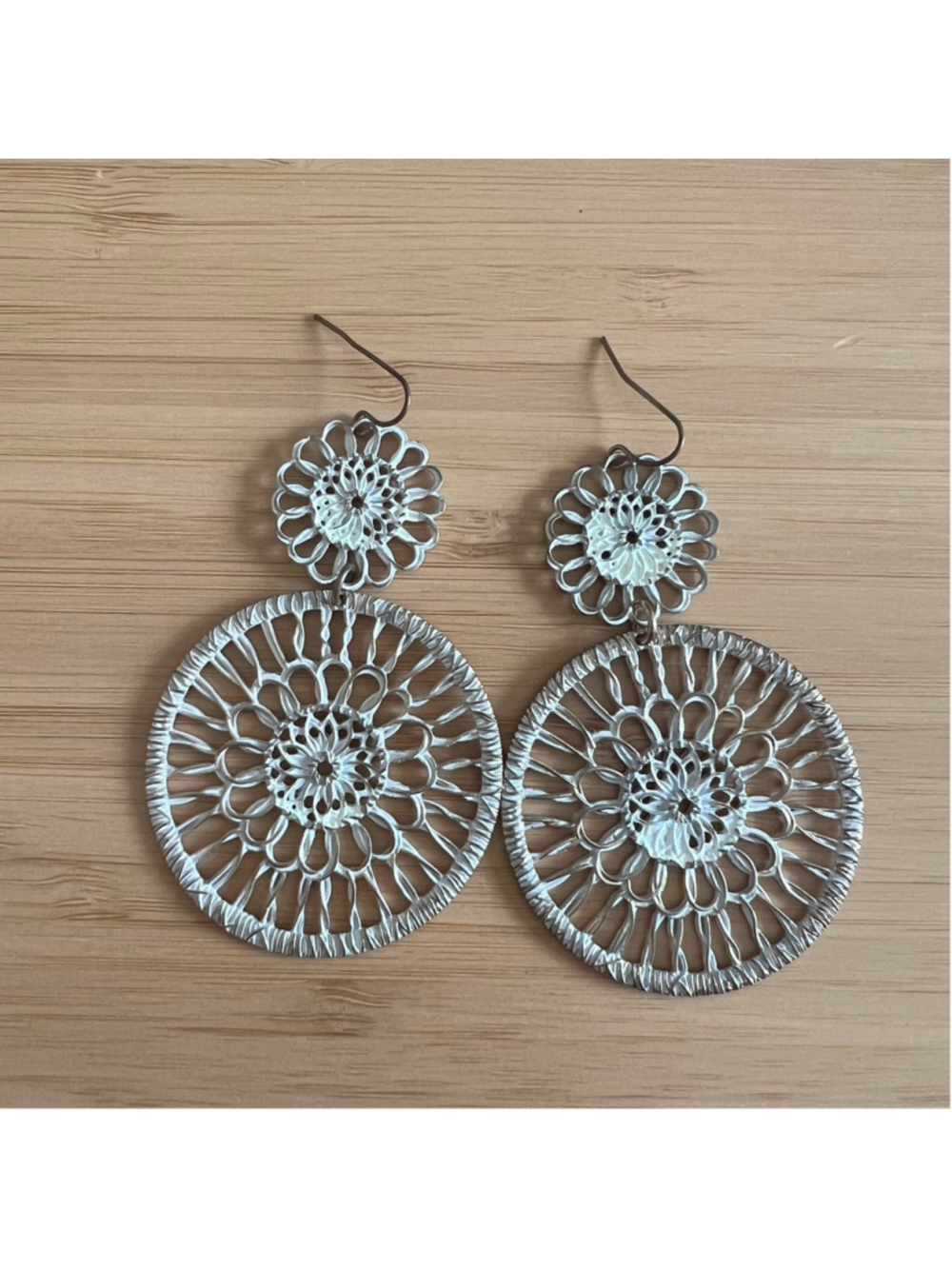 Vintage-looking gold and white earrings with a floral design